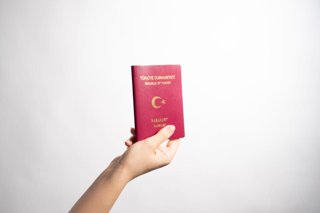 A Turkish passport held up in hand